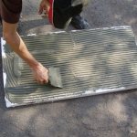 Applying glue to a sheet of foam plastic